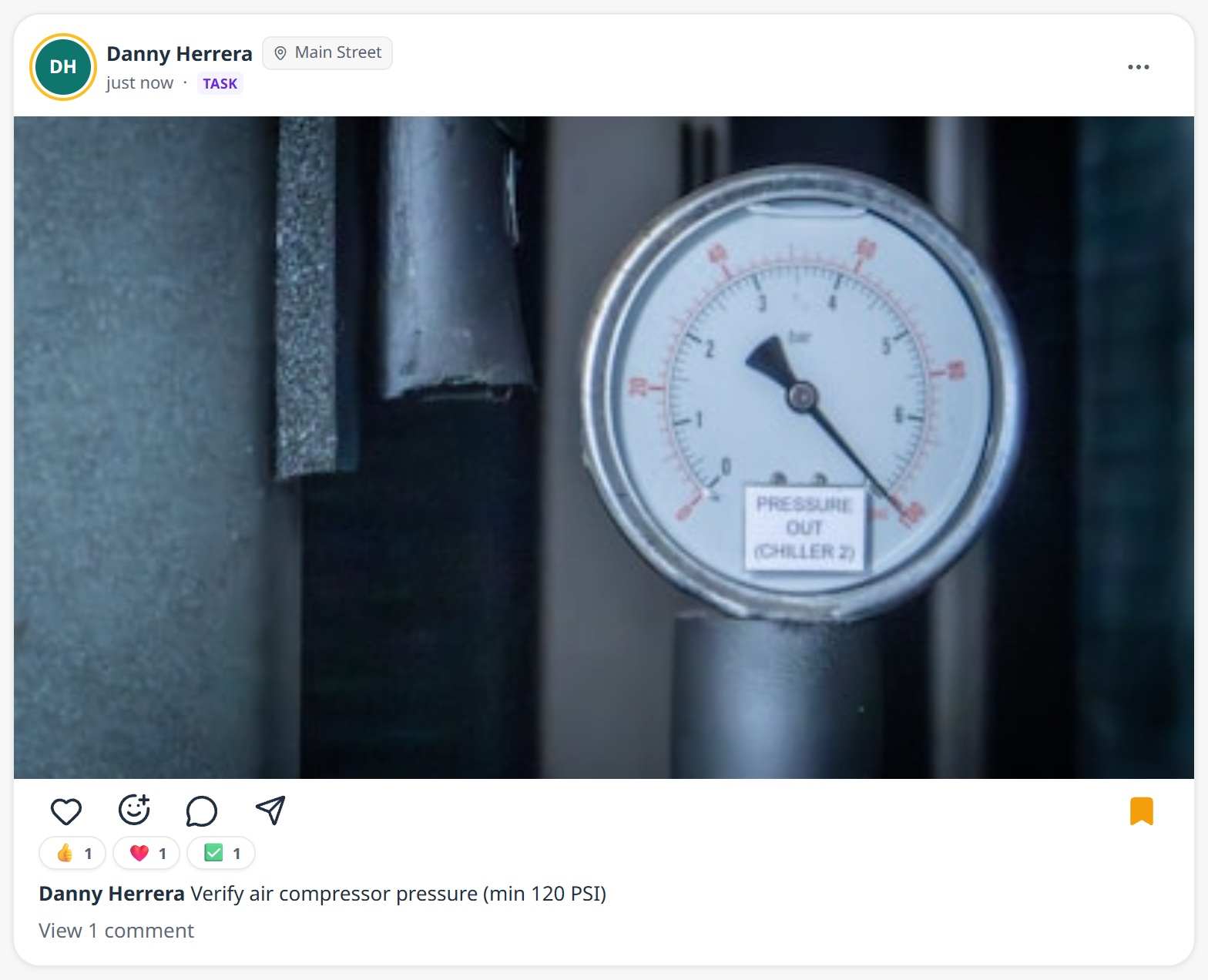 A Feed card from Danny Herrera at Main Street: a close-up photo of the Chiller 2 pressure gauge, thumbs-up, heart and check reactions, the task caption 'Verify air compressor pressure (min 120 PSI)', and one comment.