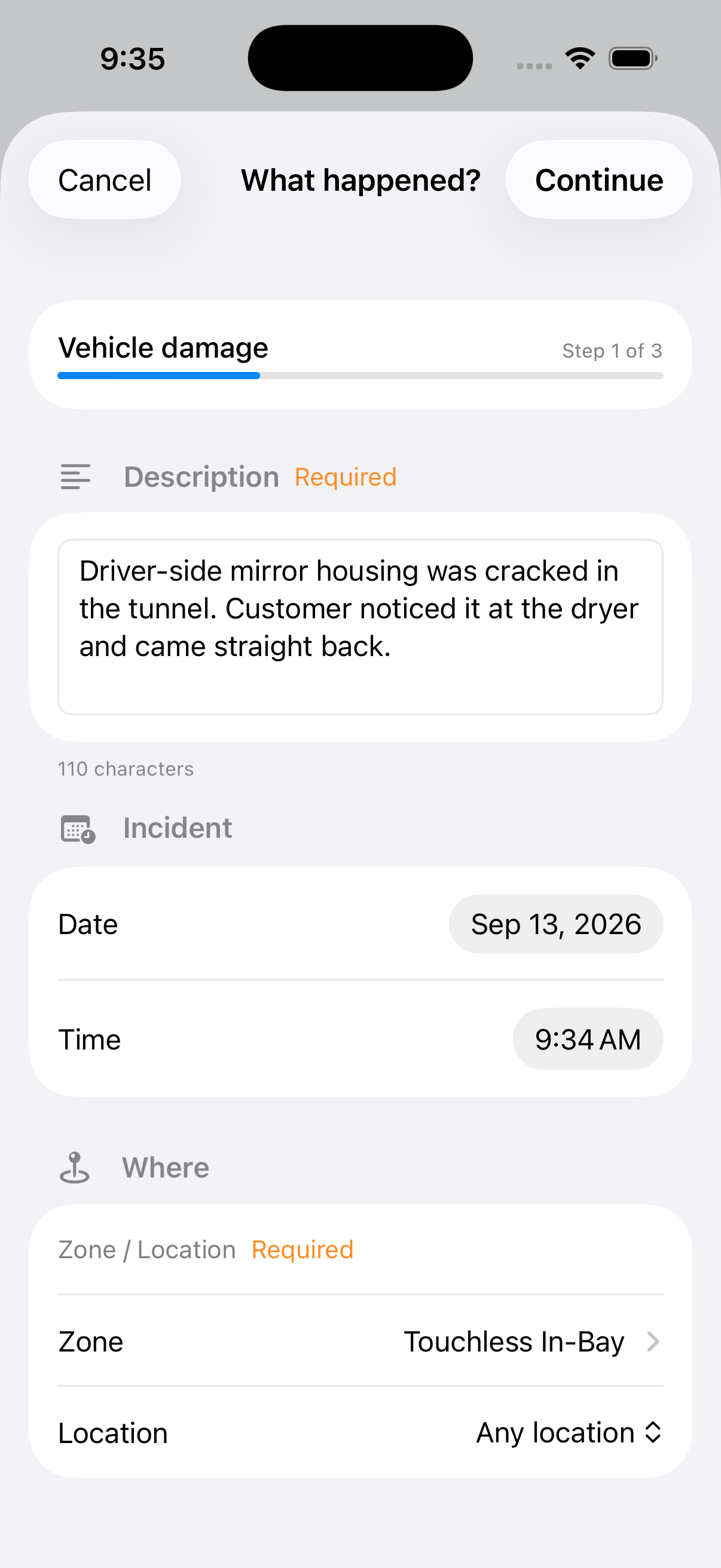 The WashConsole iOS intake on Step 1 of 3, headed What happened, showing Vehicle damage with a progress bar, a Required description reading that the driver-side mirror housing was cracked in the tunnel and the customer noticed it at the dryer, an Incident block with the date and time, and a Where block with the zone set to Touchless In-Bay.